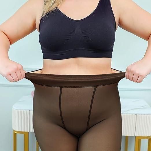 Person wearing a black sports bra and brown shapewear against a light blue background